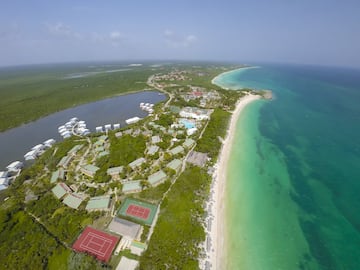 a aerial view of a beach with buildings and a body of water
