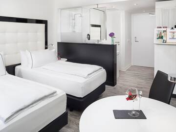 a room with two beds and a glass wall