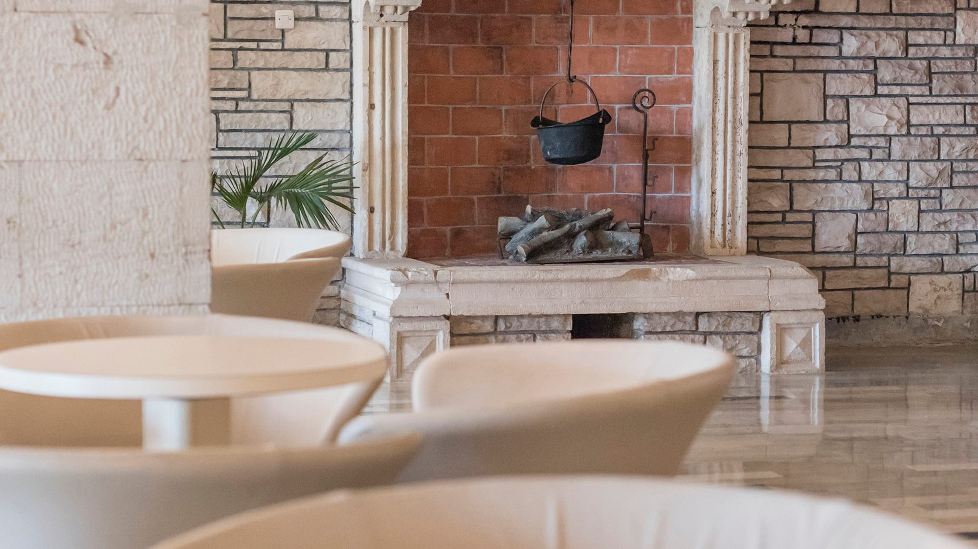 a fireplace with a pot from it