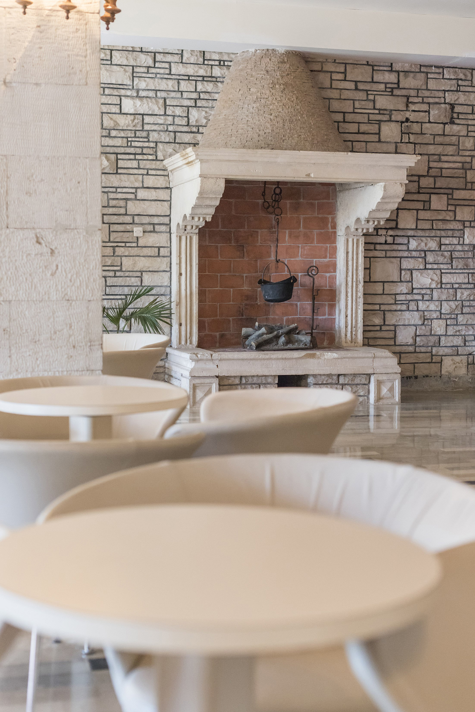 a fireplace with a pot from it