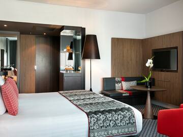 a room with a bed and a tv