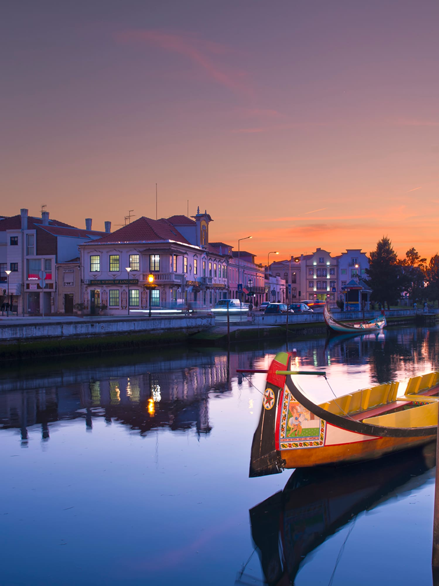 boats on a river with buildings in the background