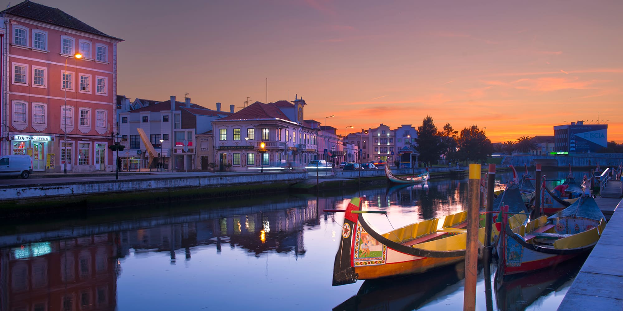 boats on a river with buildings in the background