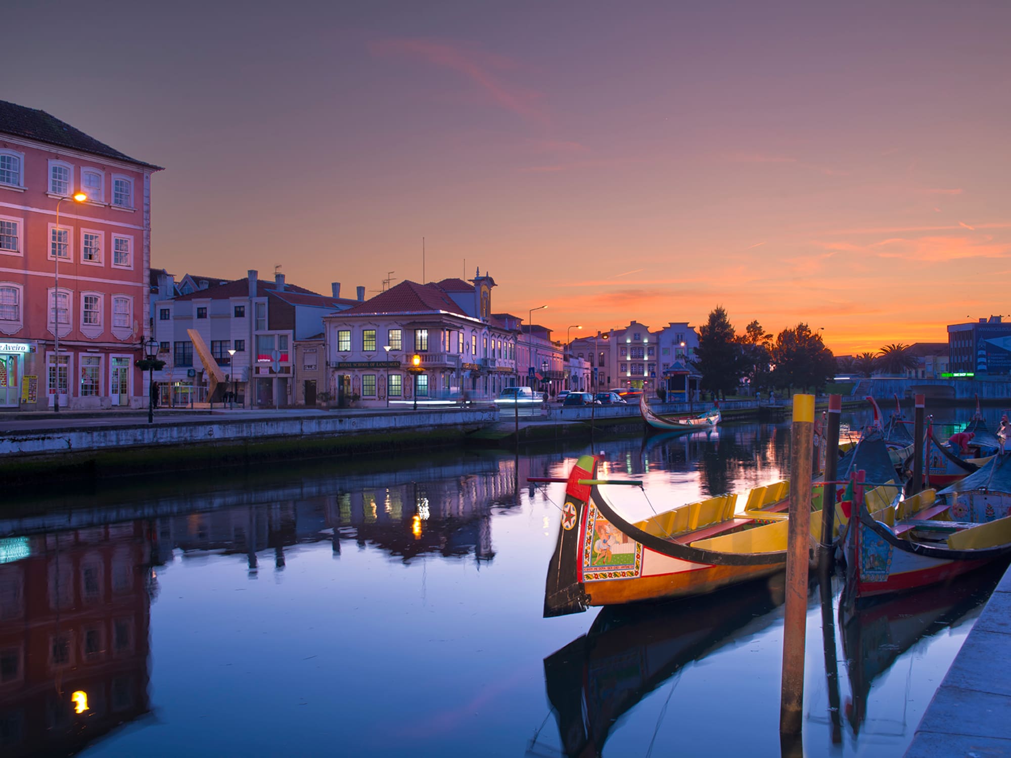 boats on a river with buildings in the background