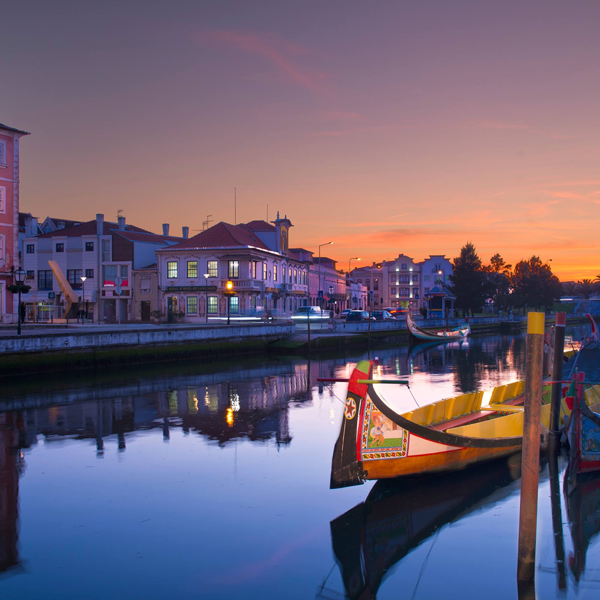 boats on a river with buildings in the background