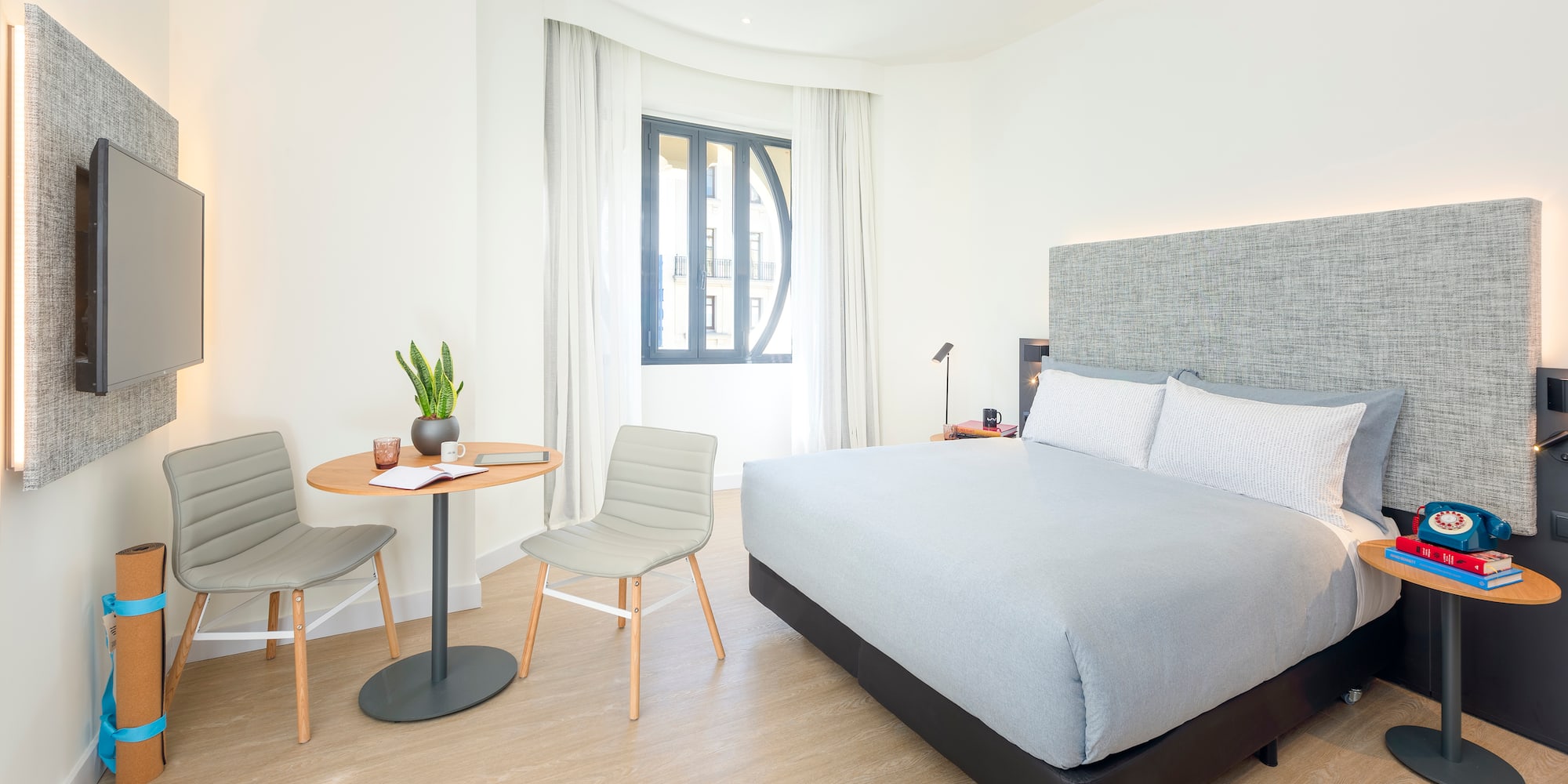 a bedroom with a bed and chairs