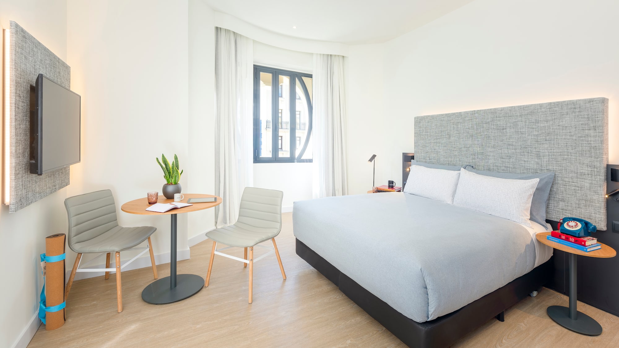 a bedroom with a bed and chairs