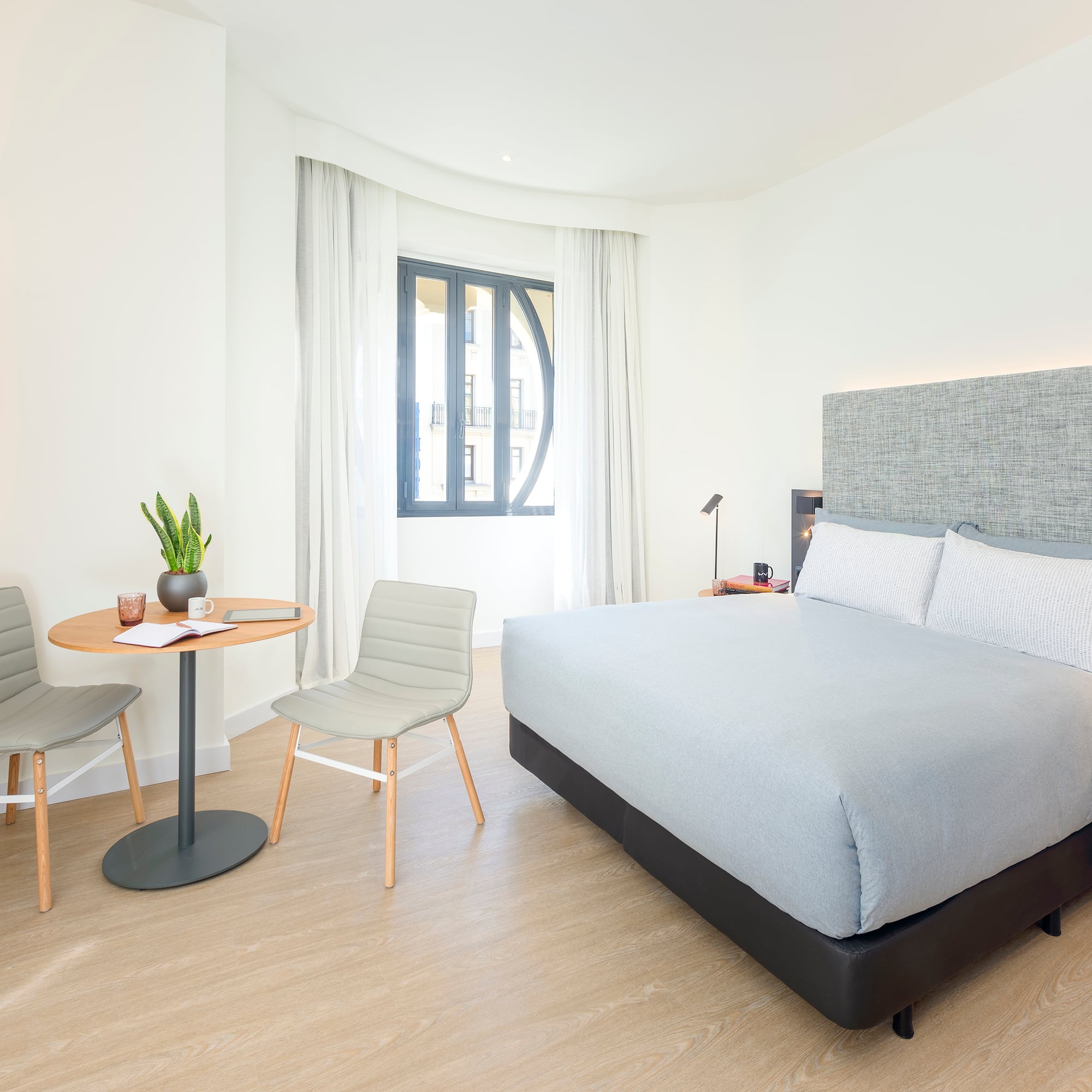 a bedroom with a bed and chairs