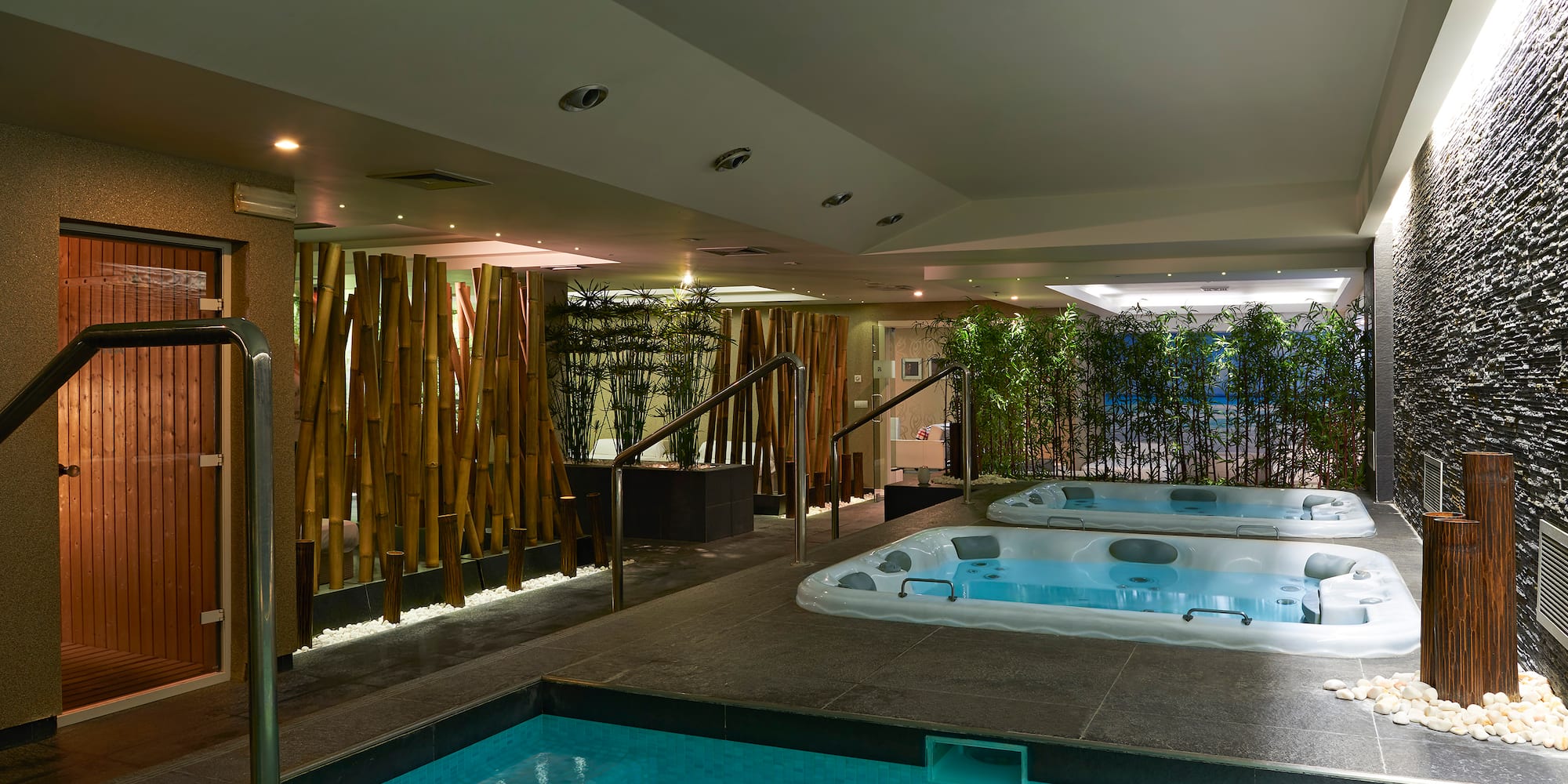 a indoor pool with hot tubs.