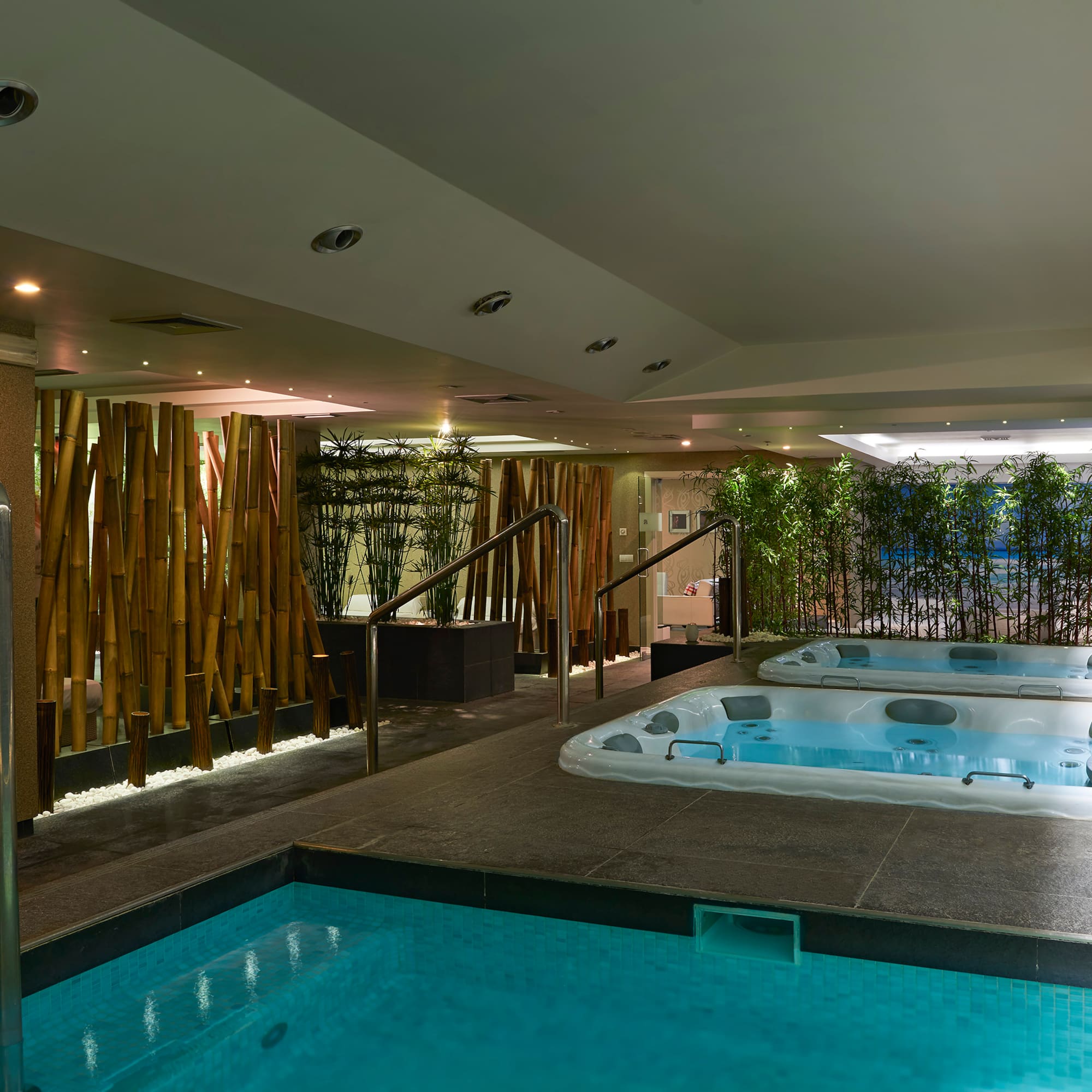 a indoor pool with hot tubs.