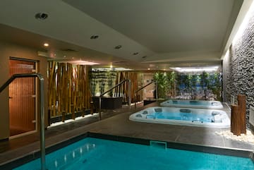 a indoor pool with hot tubs.