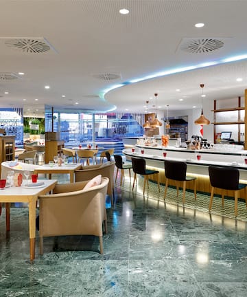 a restaurant with tables and chairs.