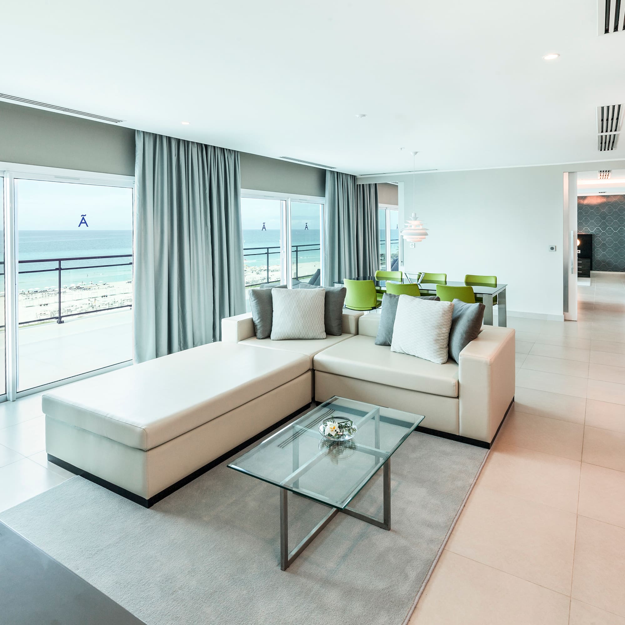 a living room with a large glass table and couch