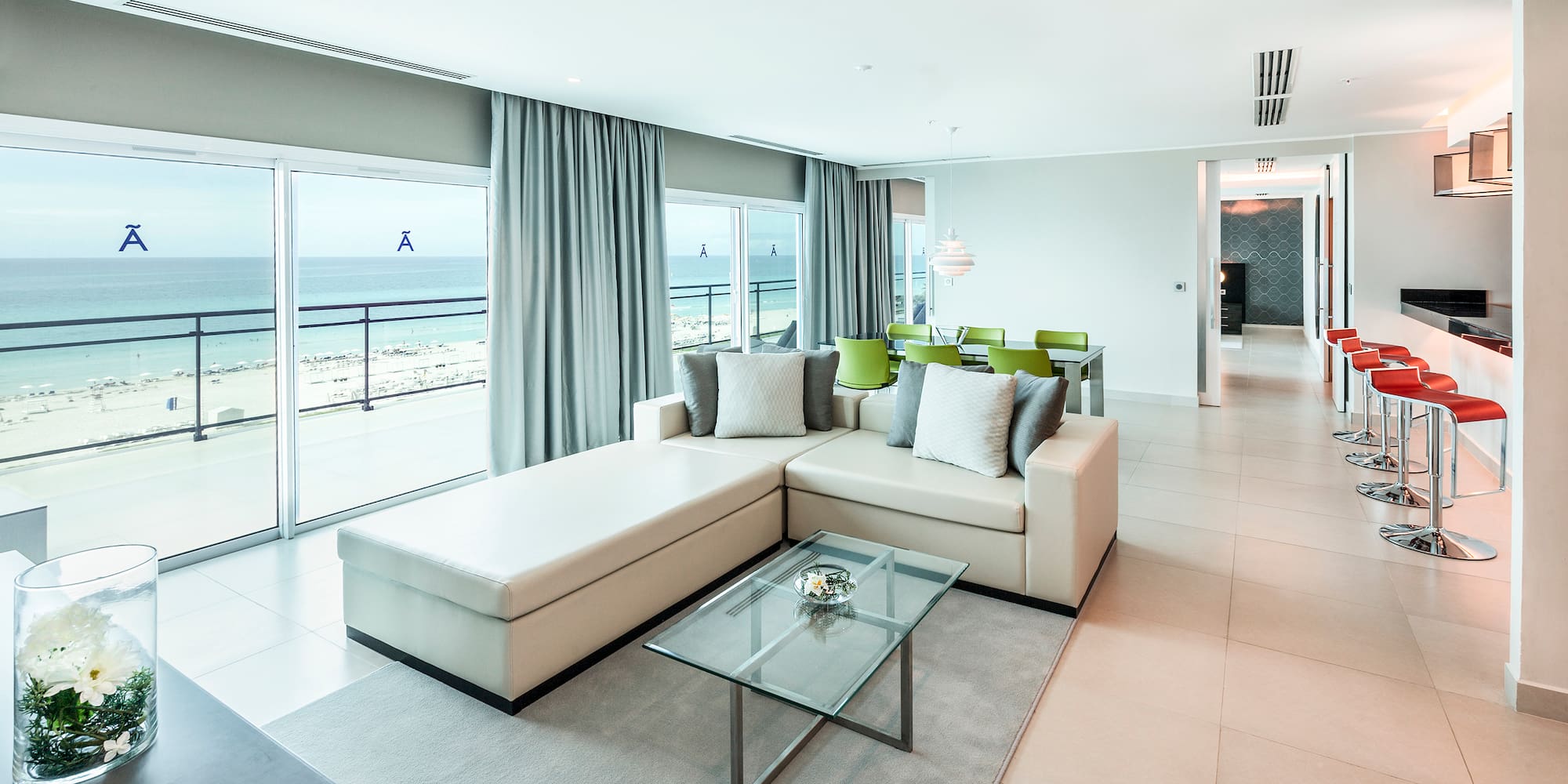 a living room with a large glass table and couch