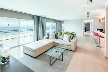 a living room with a large glass table and couch