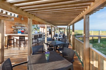a patio with tables and chairs
