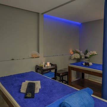 a massage table with blue towels and a towel on it