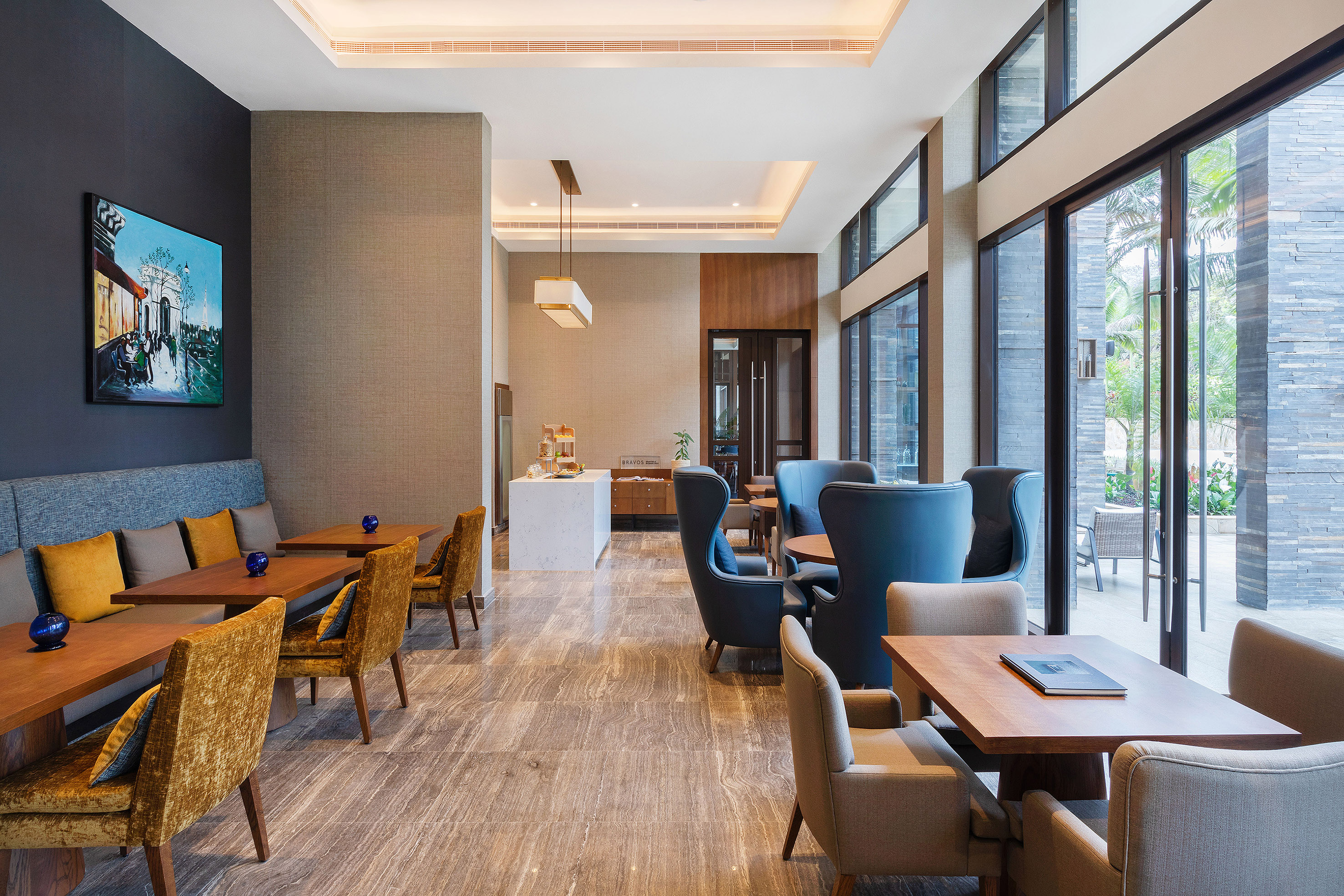 Spacious hotel lounge with varied seating and floor-to-ceiling windows.