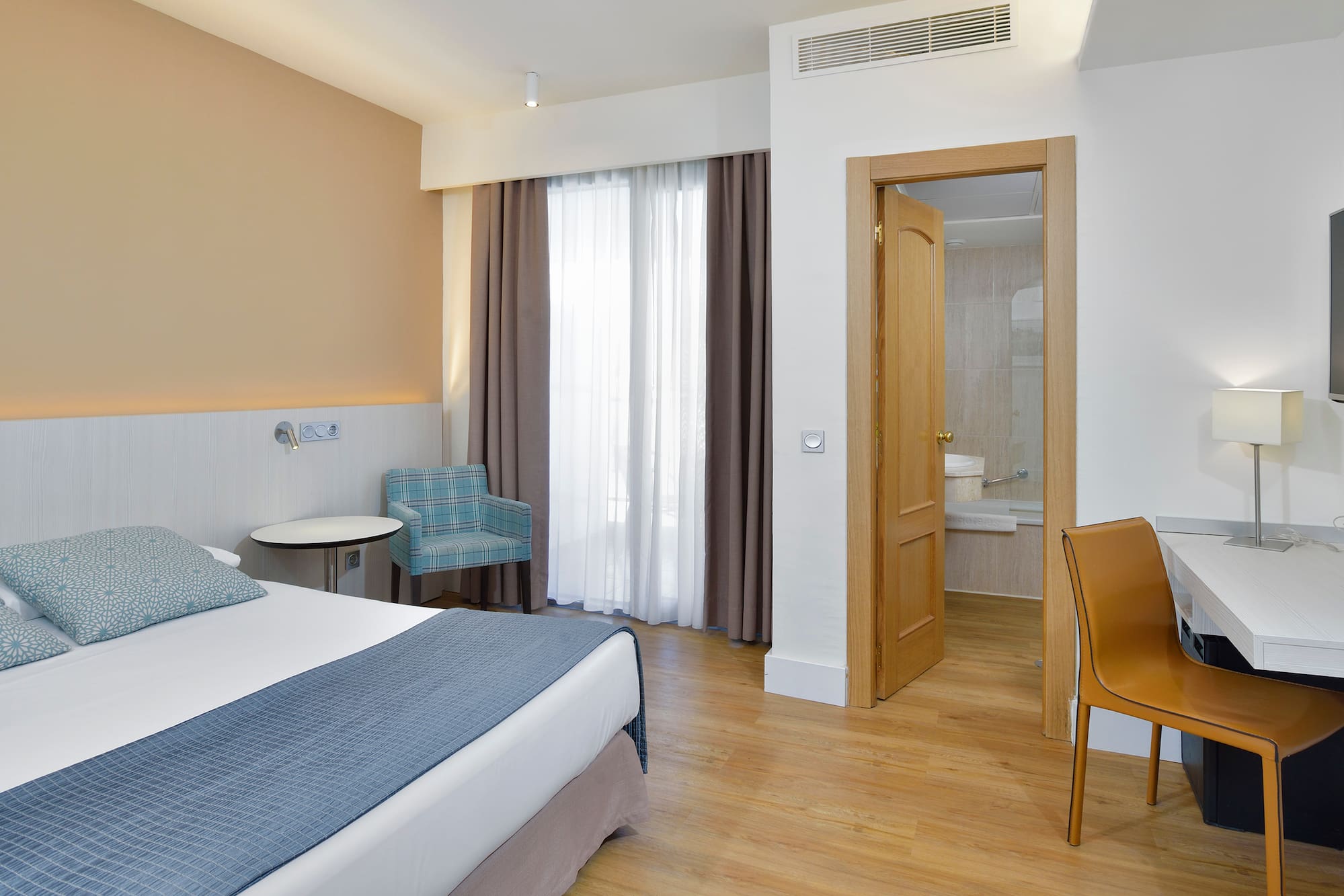 a room with a bed and a chair