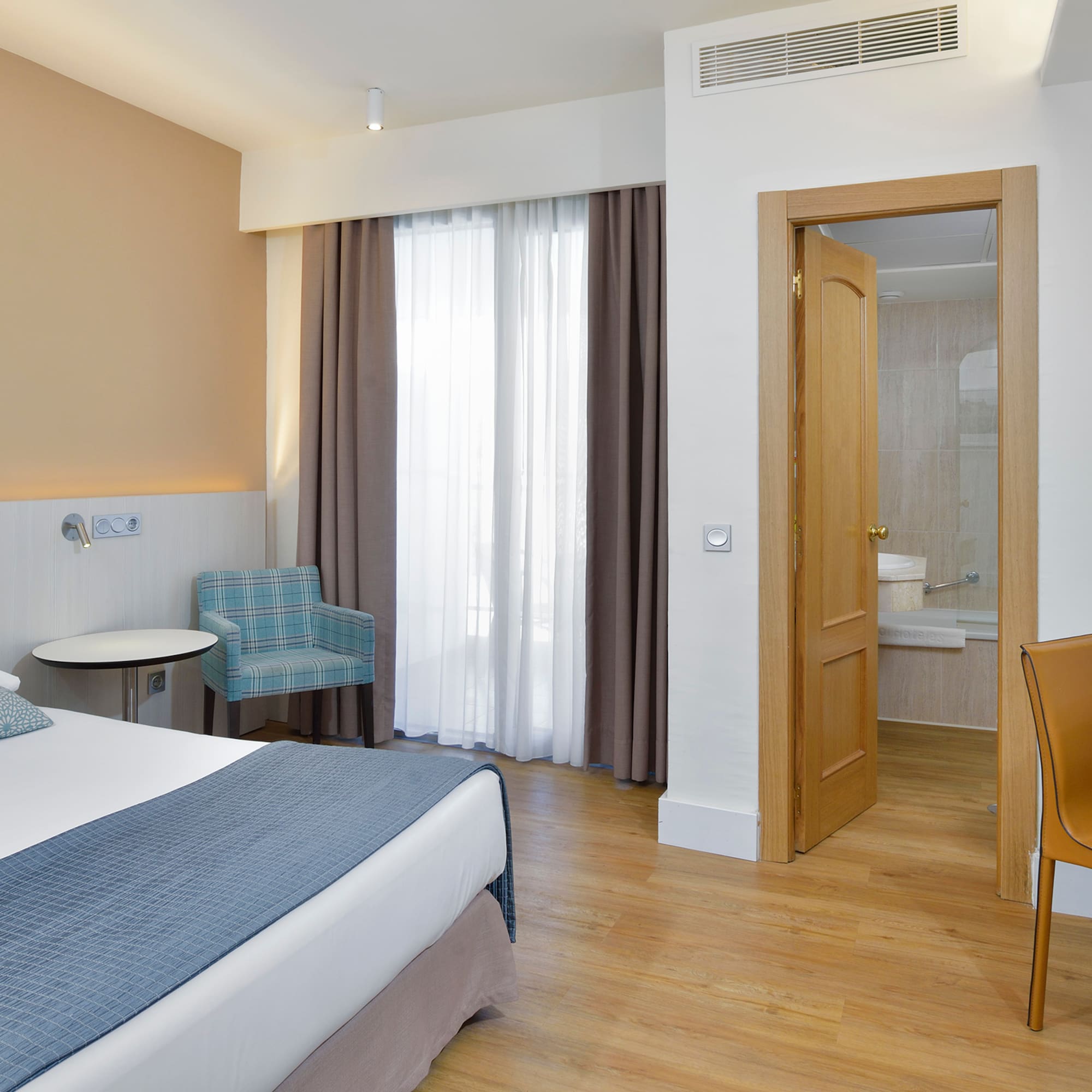 a room with a bed and a chair