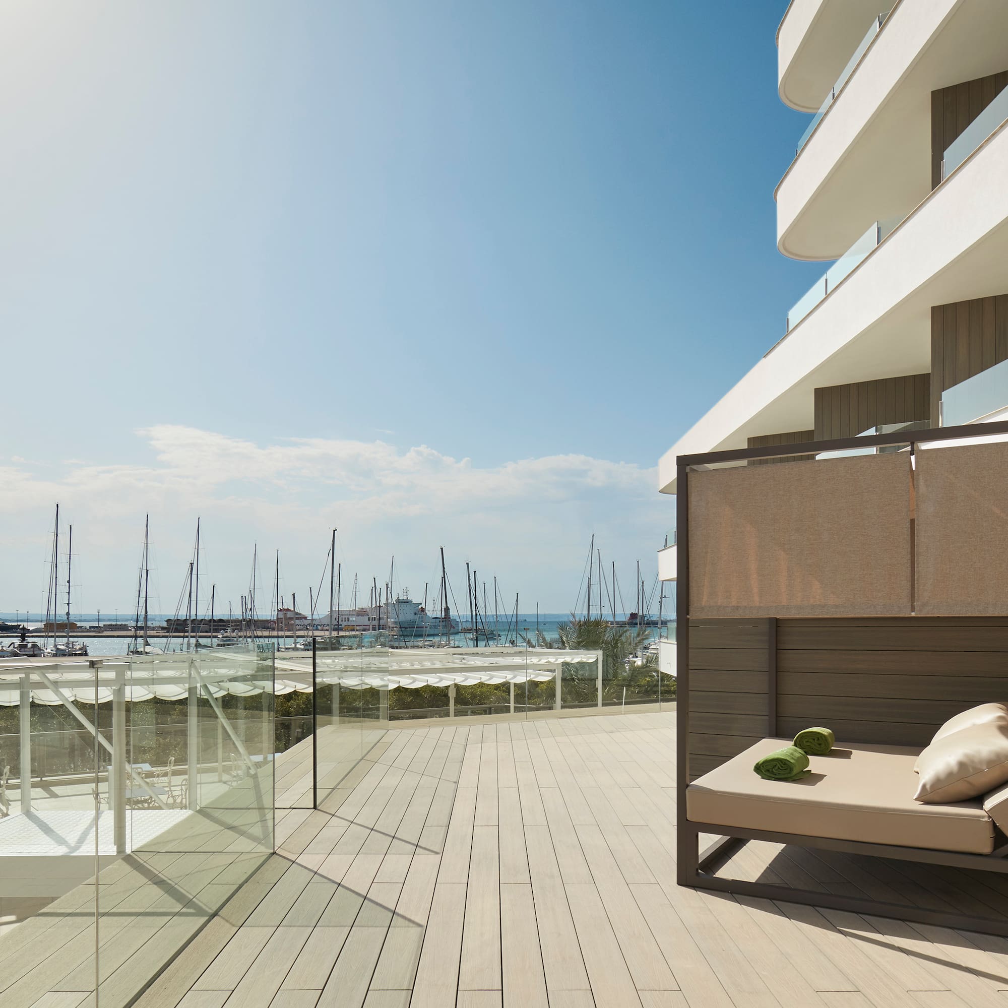 a deck with a couch and a view of the water