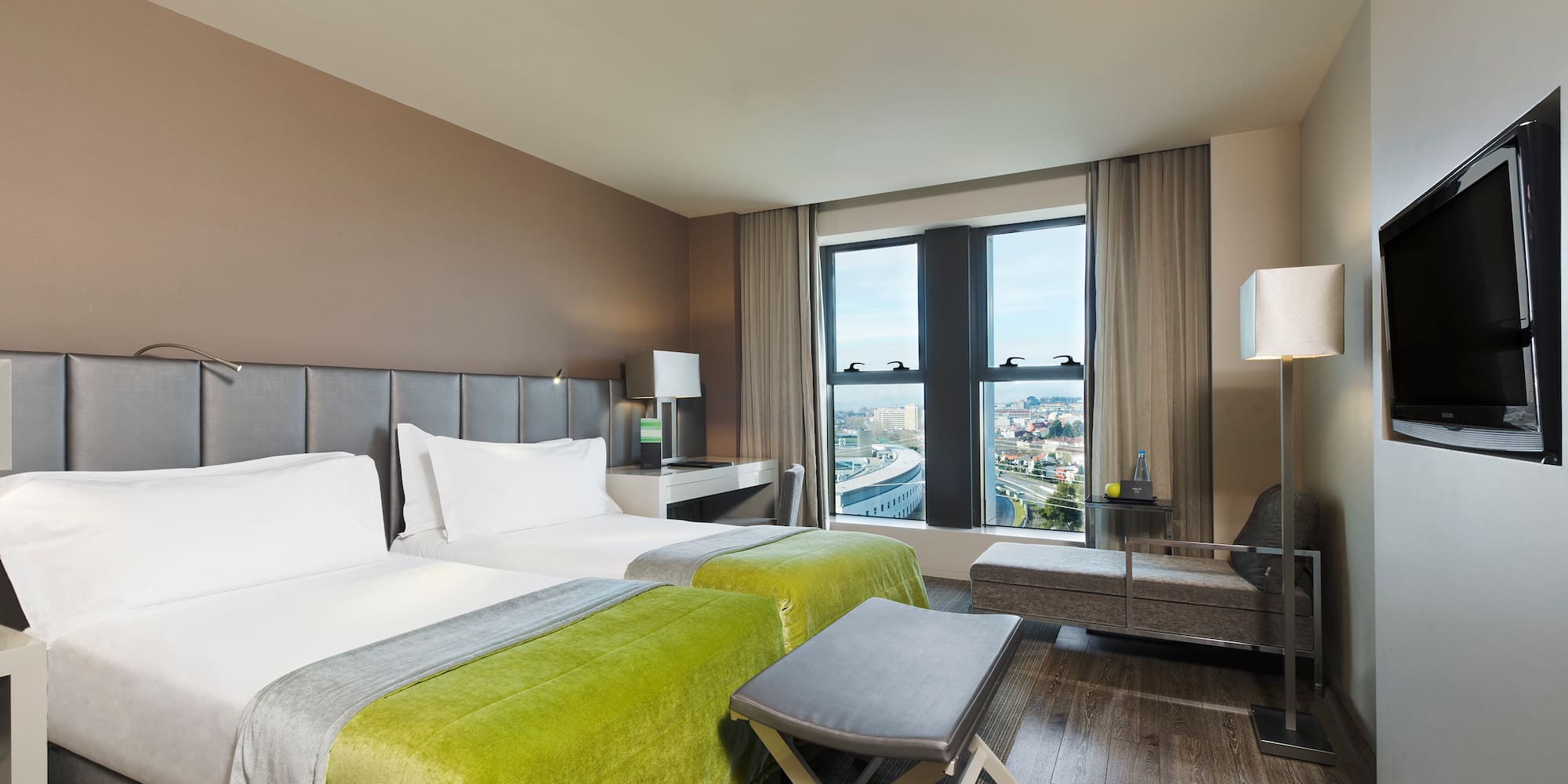 a room with two beds and a bench