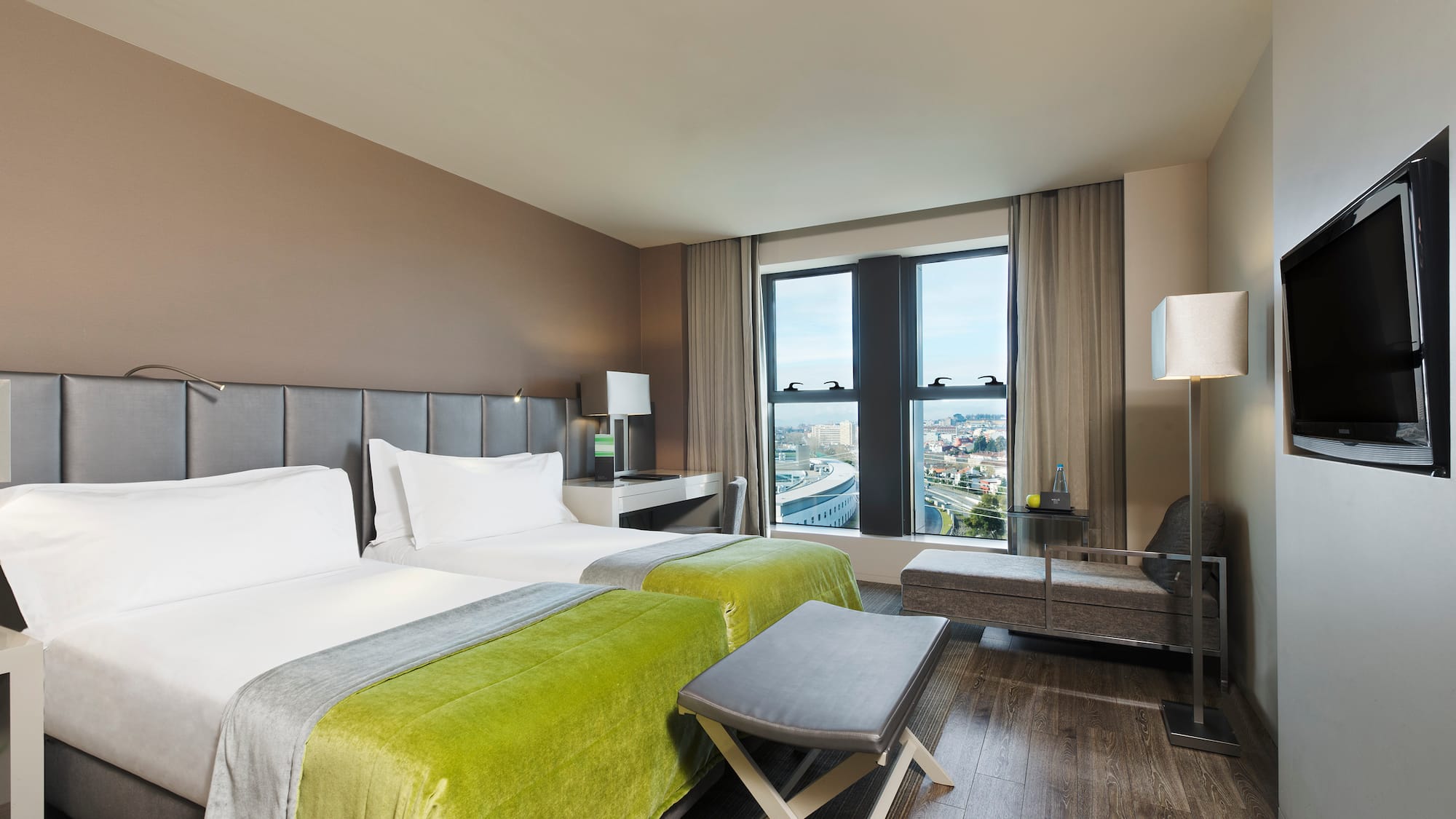 a room with two beds and a bench