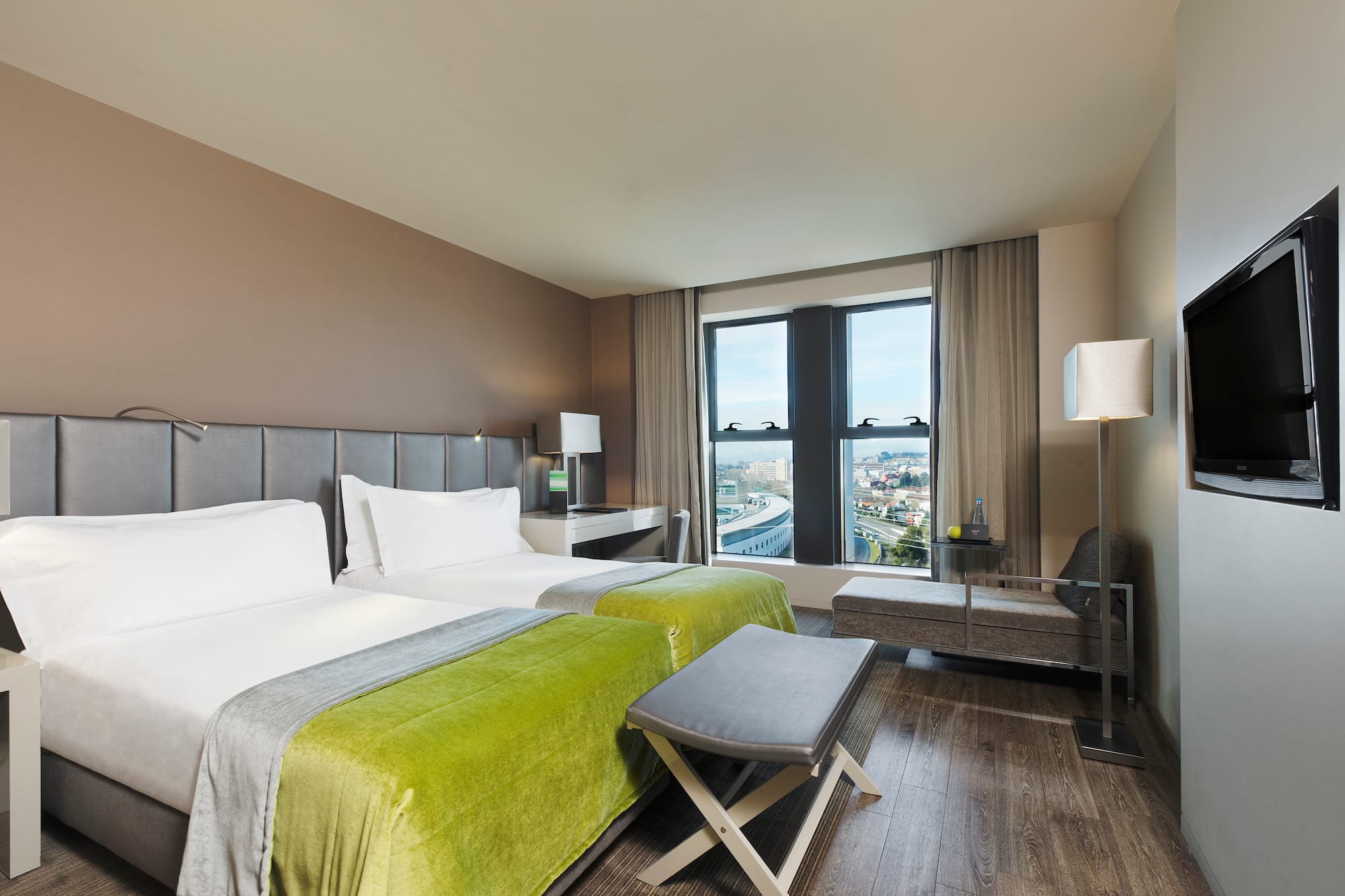 a room with two beds and a bench