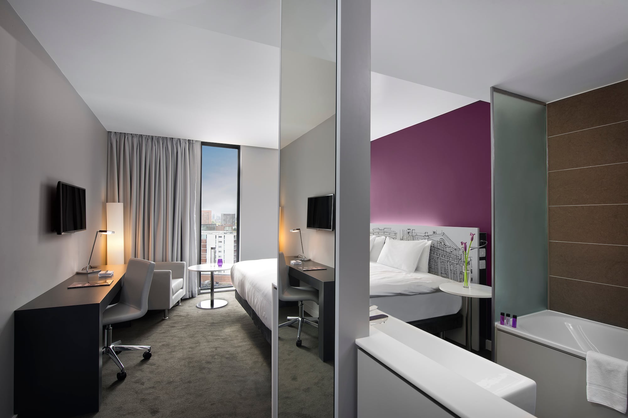 a room with a bed and a desk