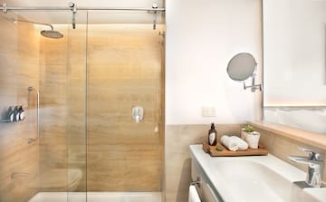a bathroom with a glass shower door