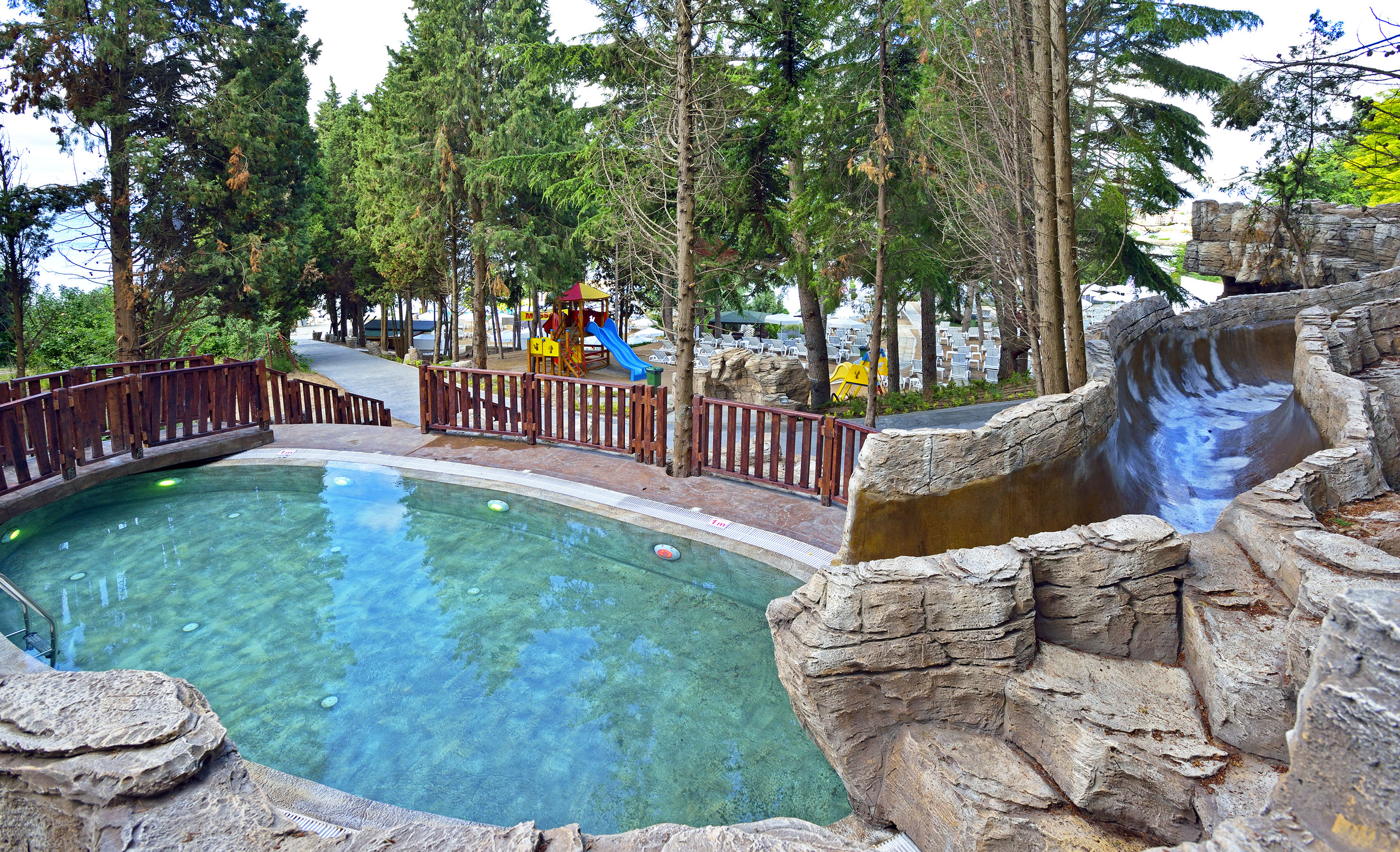 a pool with a slide and trees - SOL Nessebar Resort Aquapark - SOL Nessebar Mare All Inclusive, Nesebar