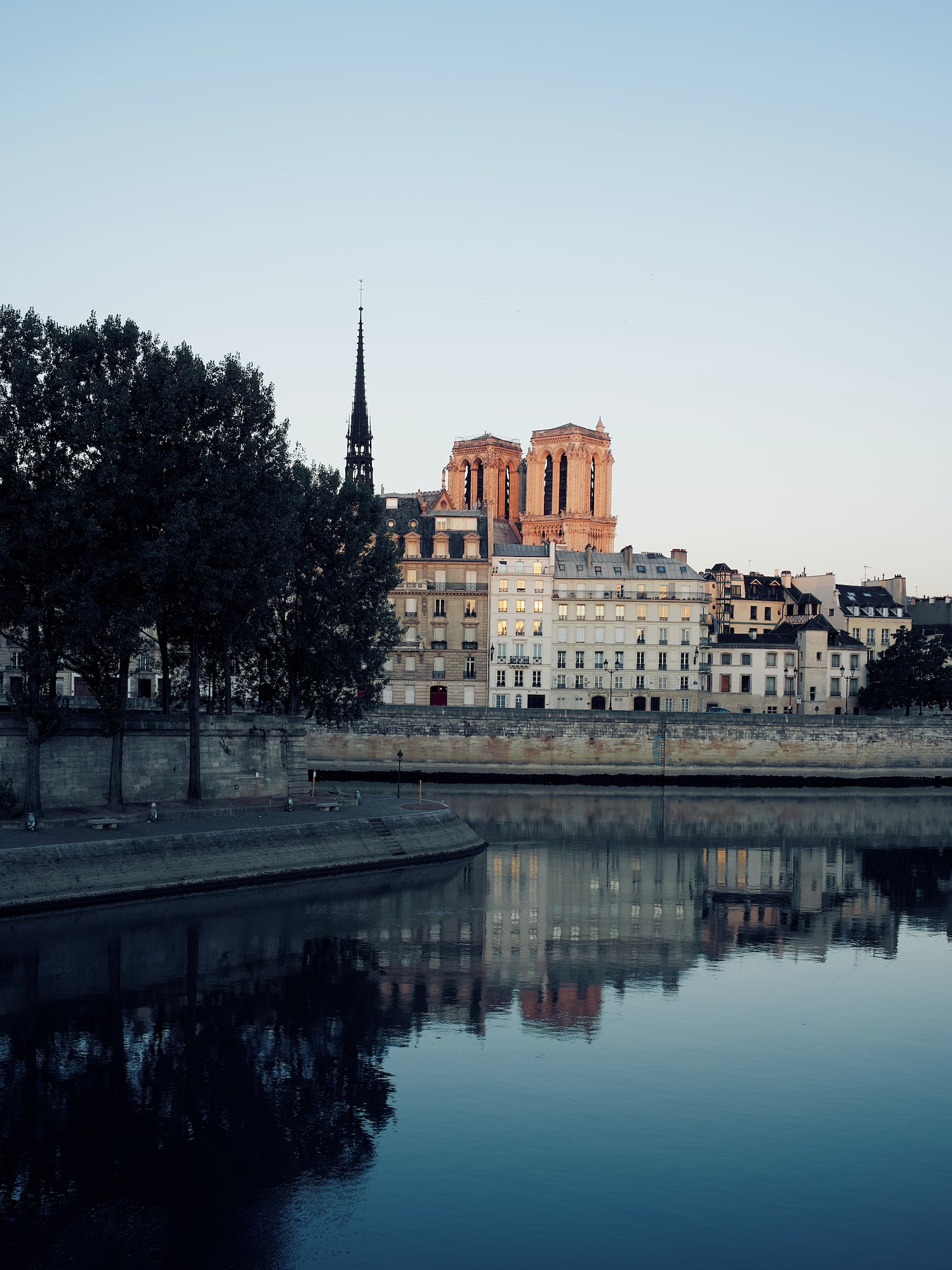 a body of water with buildings and trees