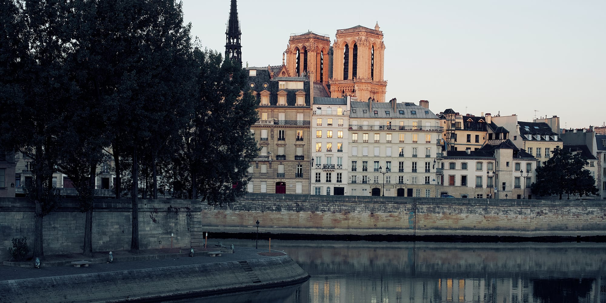a body of water with buildings and trees