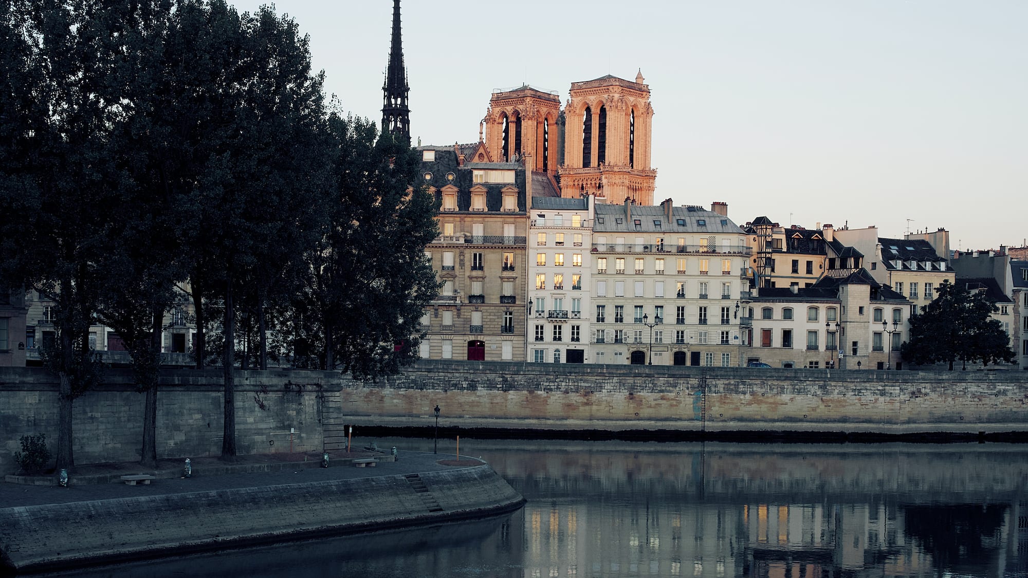 a body of water with buildings and trees
