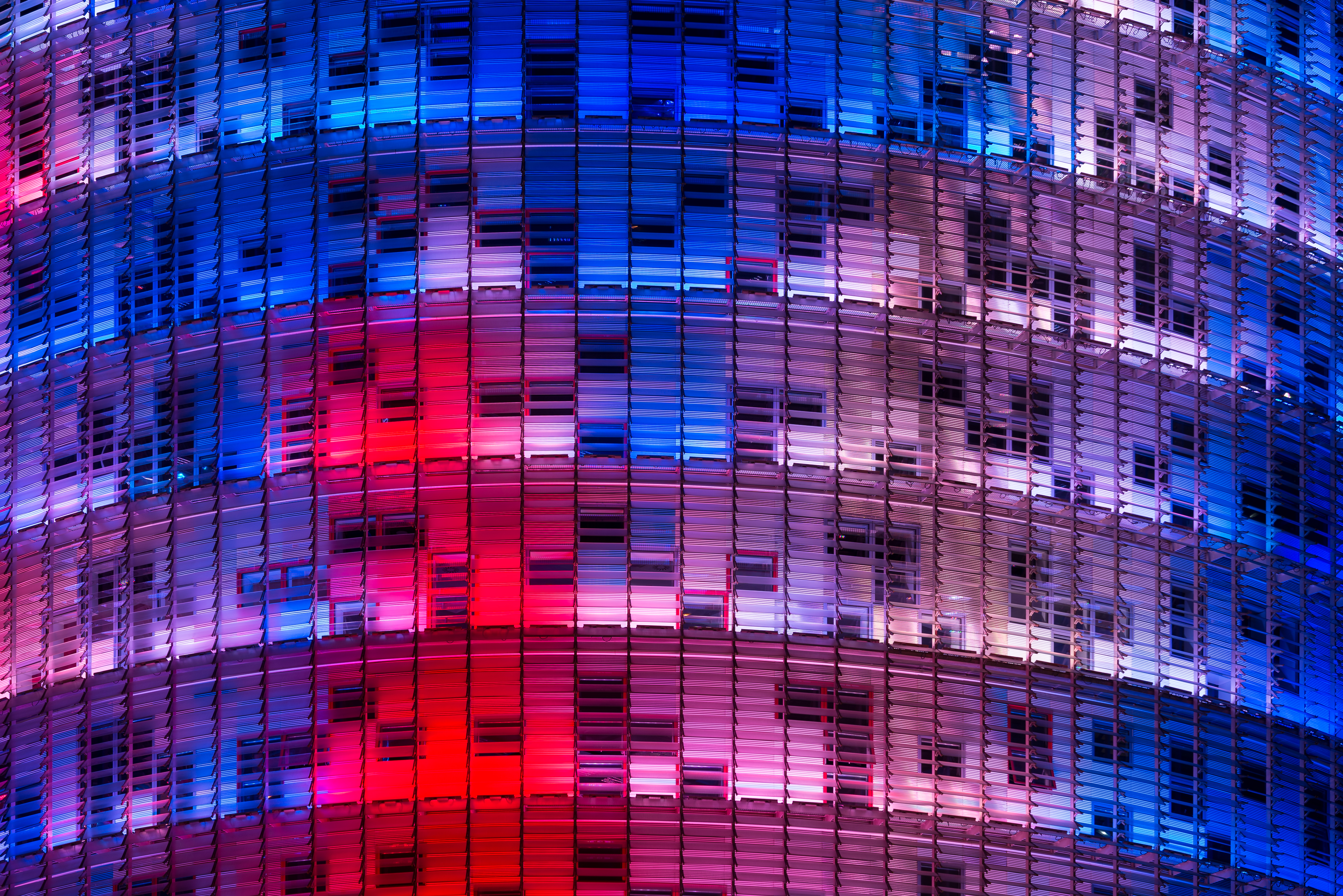 a multi colored building with many windows