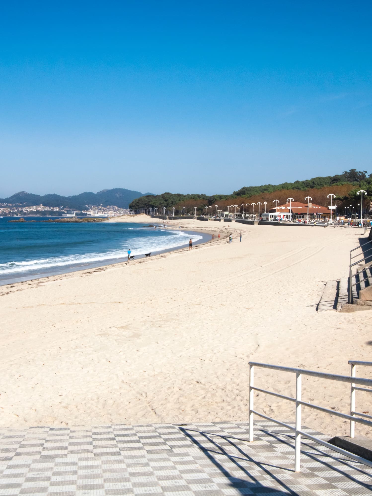 a beach with stairs leading to the water