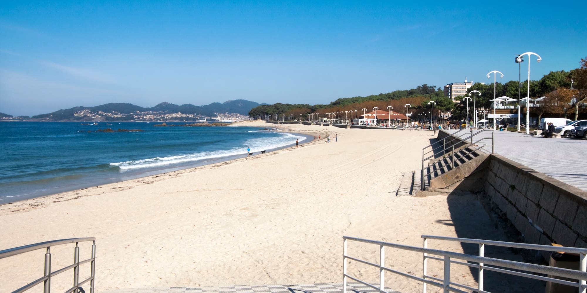 a beach with stairs leading to the water