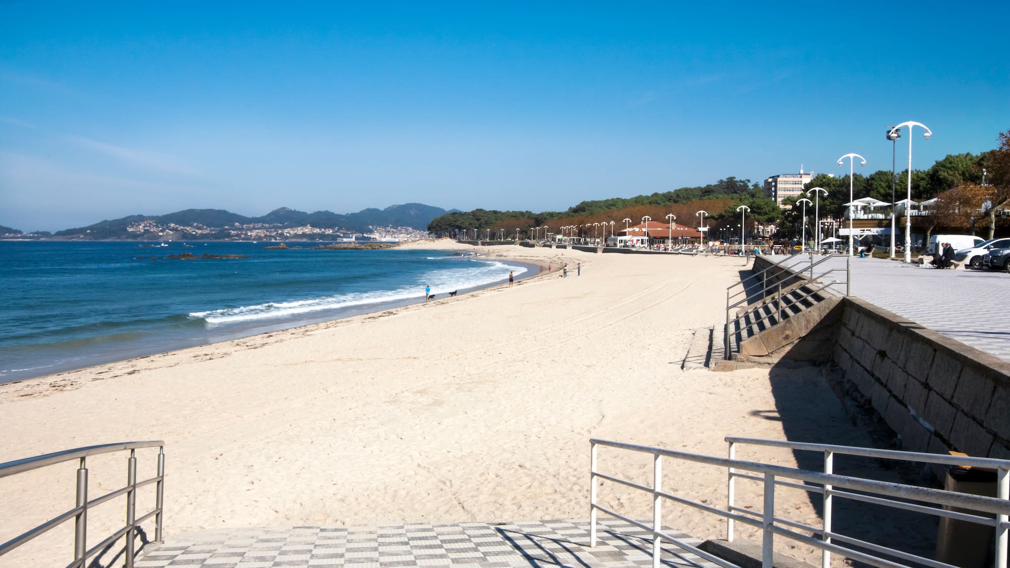 a beach with stairs leading to the water