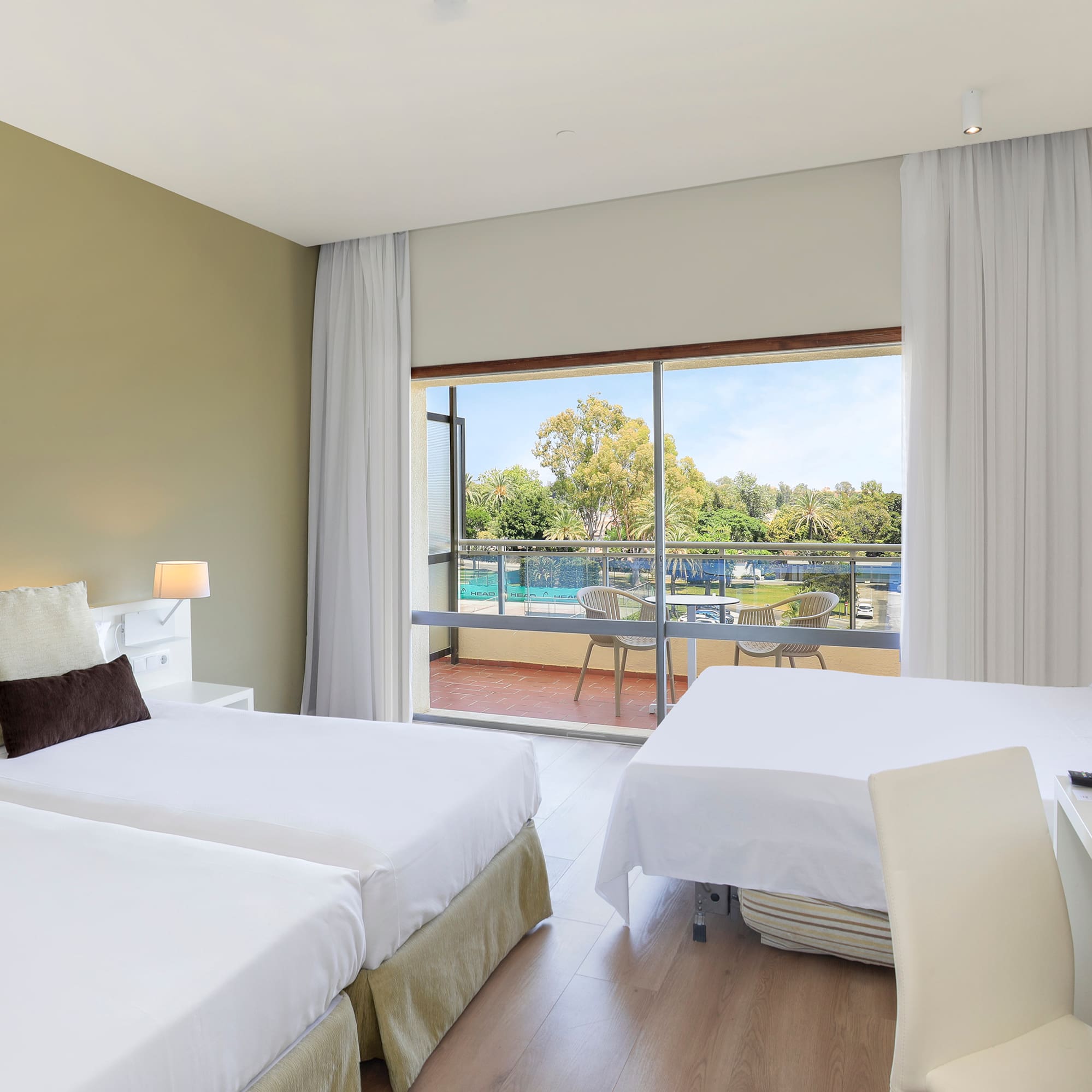 a room with two beds and a glass door