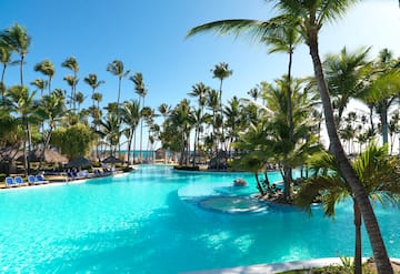 a pool with palm trees and a fountain