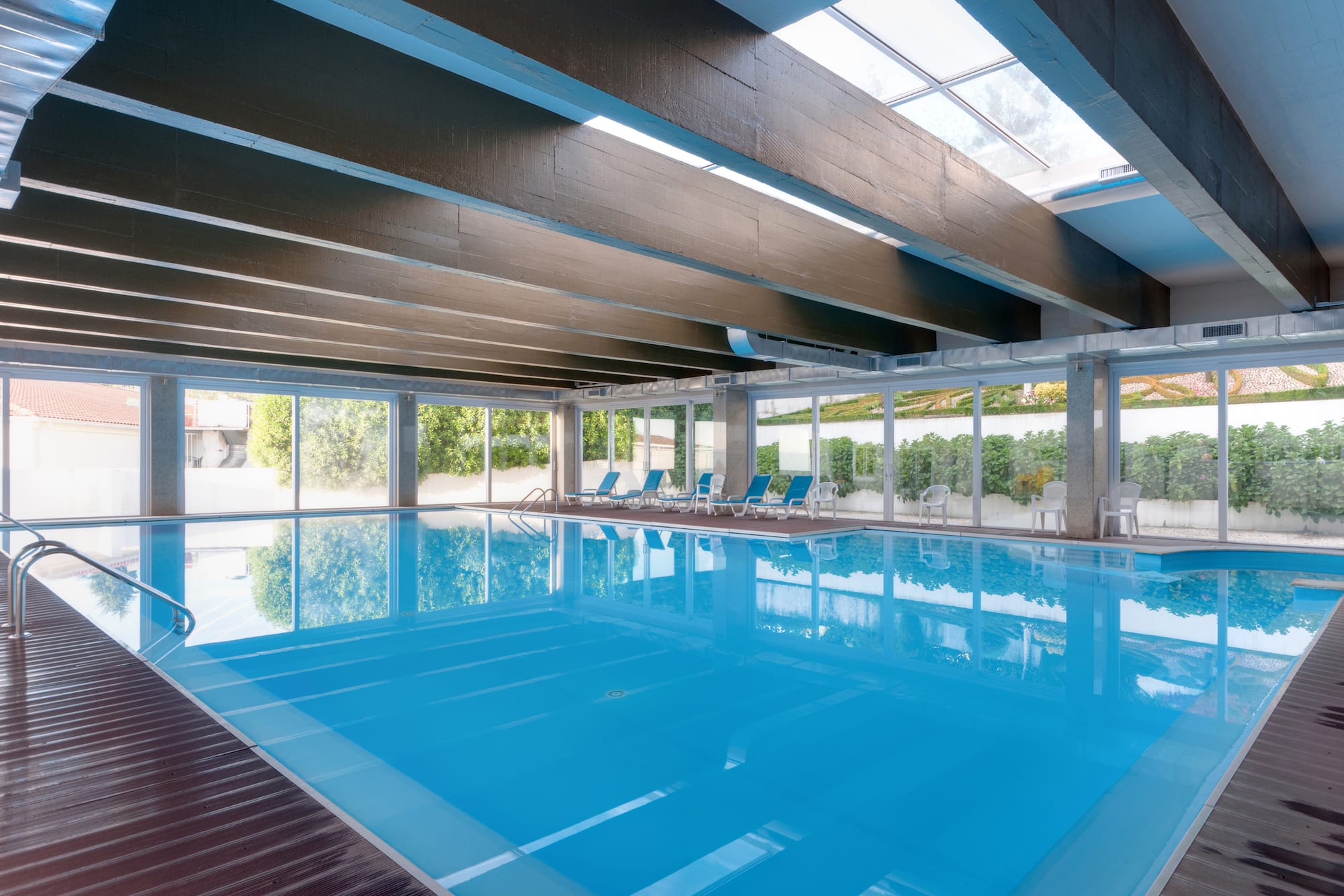 a swimming pool with chairs and a roof