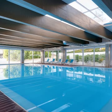 a swimming pool with chairs and windows