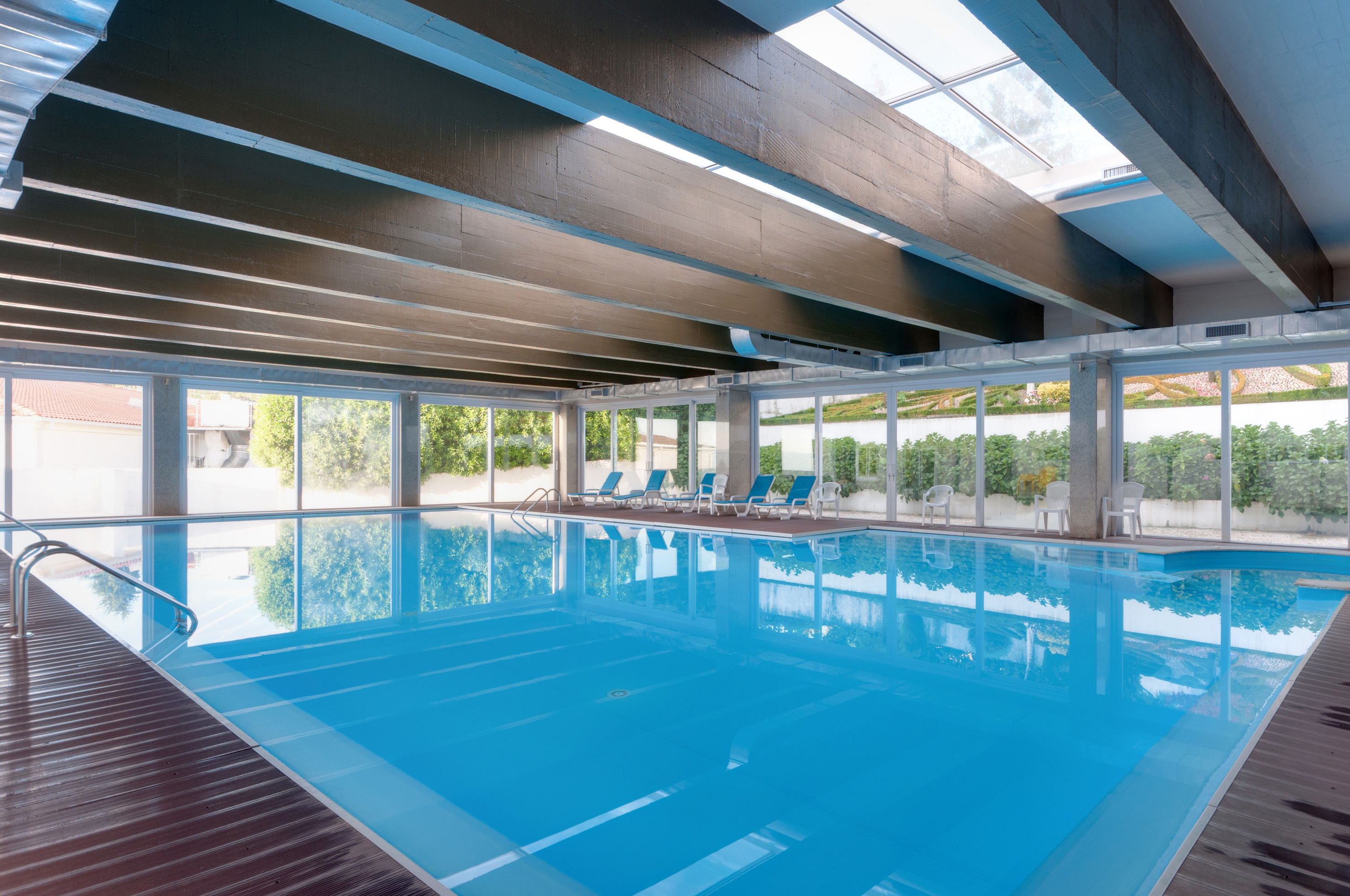 a swimming pool with chairs and a roof