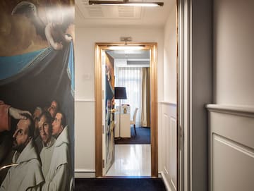 a hallway with a painting on the wall