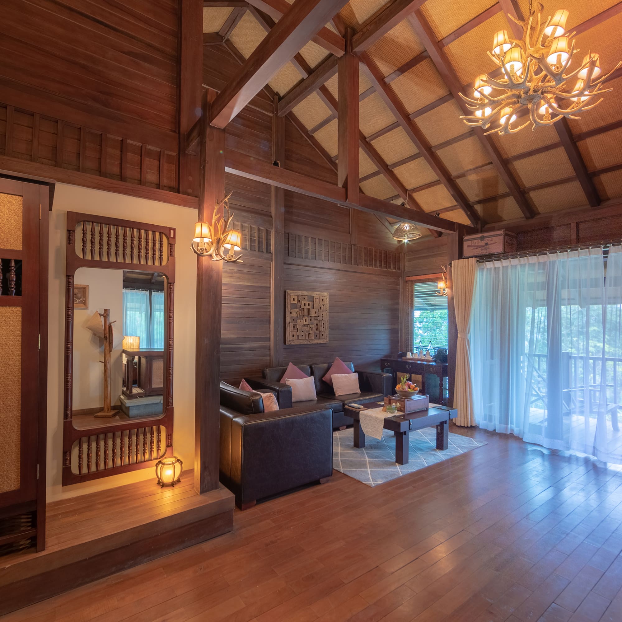 a room with a wood ceiling and a chandelier