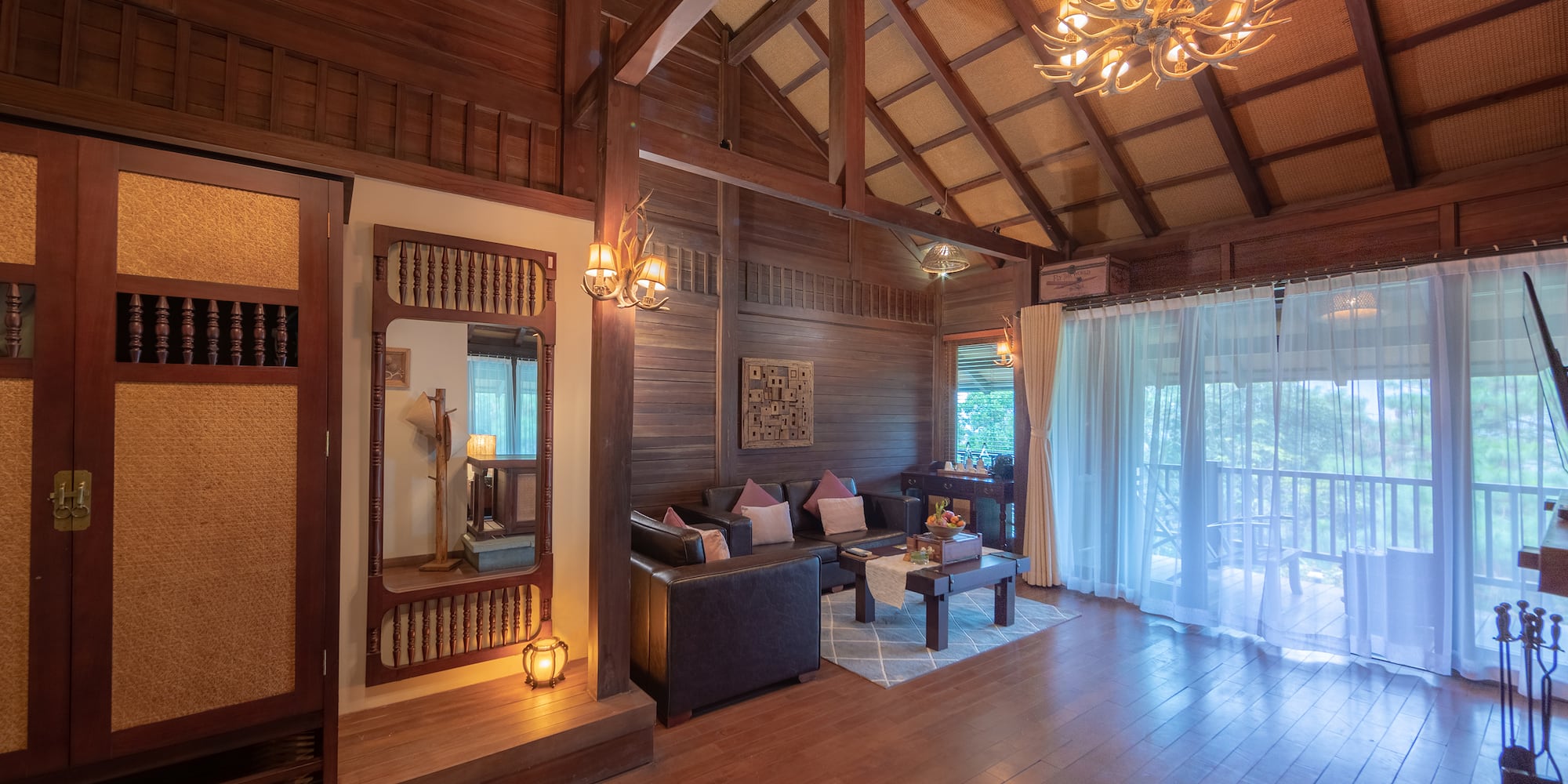 a room with a wood ceiling and a chandelier