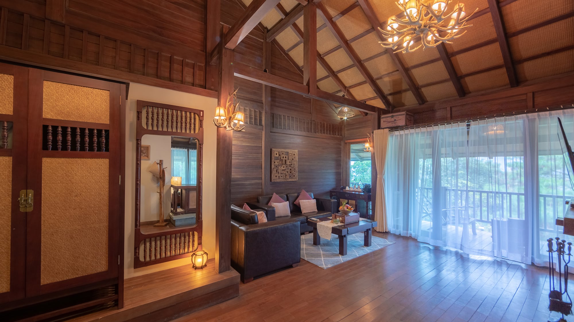 a room with a wood ceiling and a chandelier