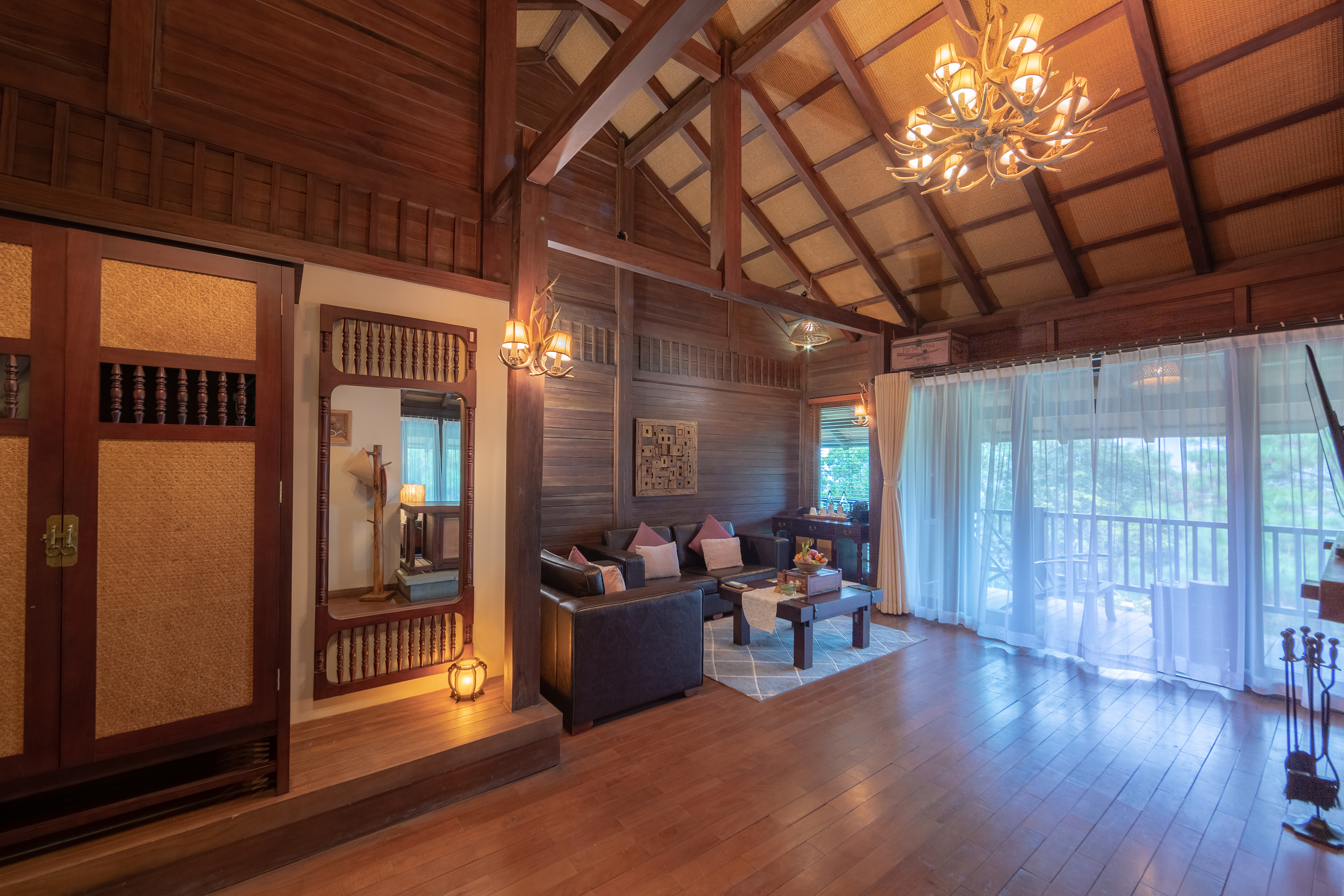 a room with a wood ceiling and a chandelier