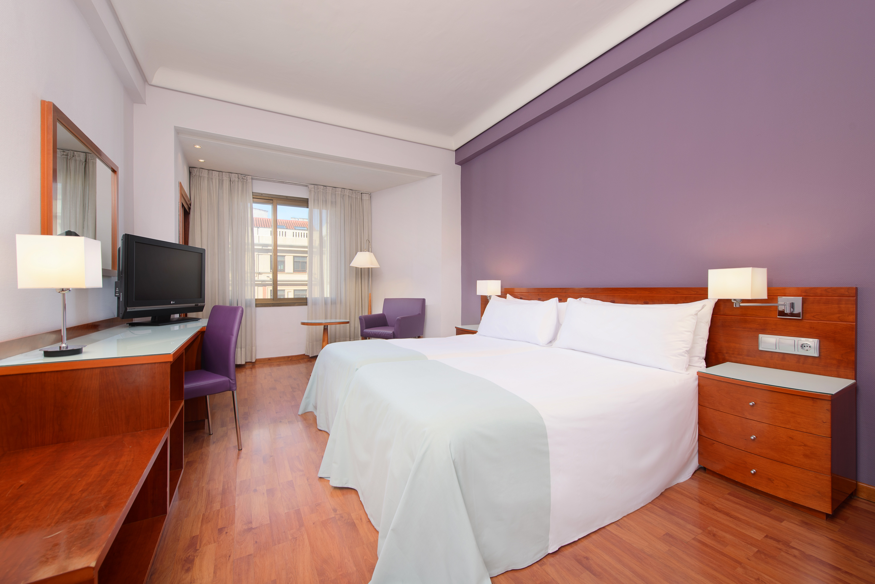 a room with a bed and a desk