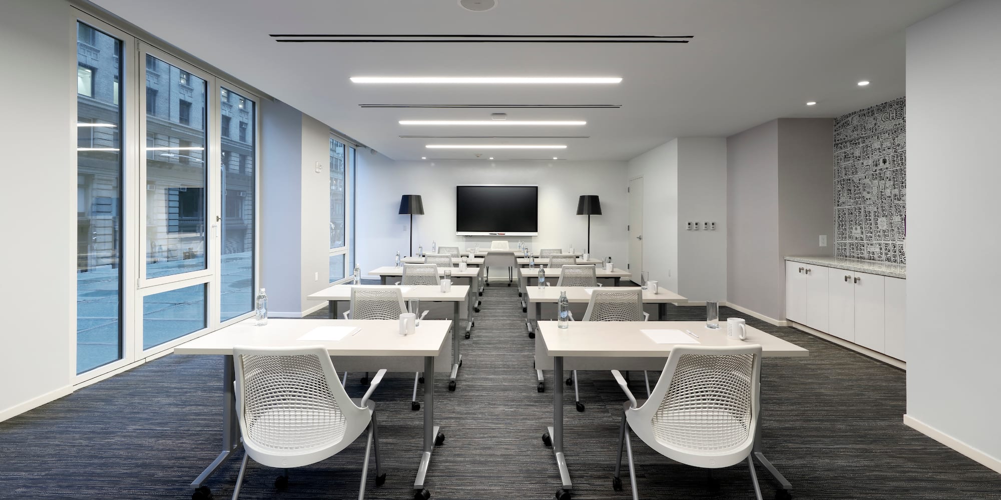 a room with white tables and chairs